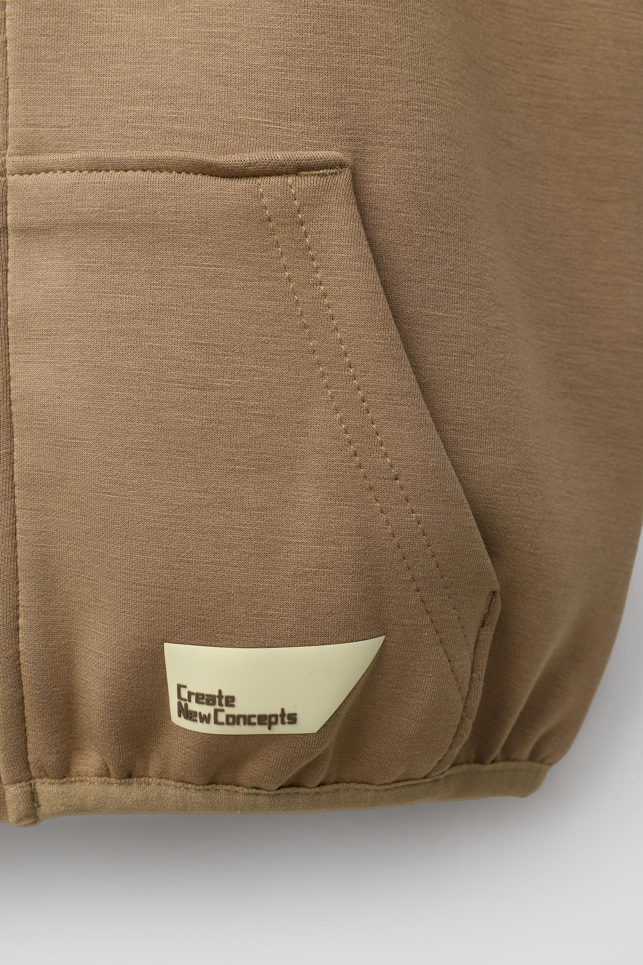 GILET À CAPUCHE EN INTERLOCK